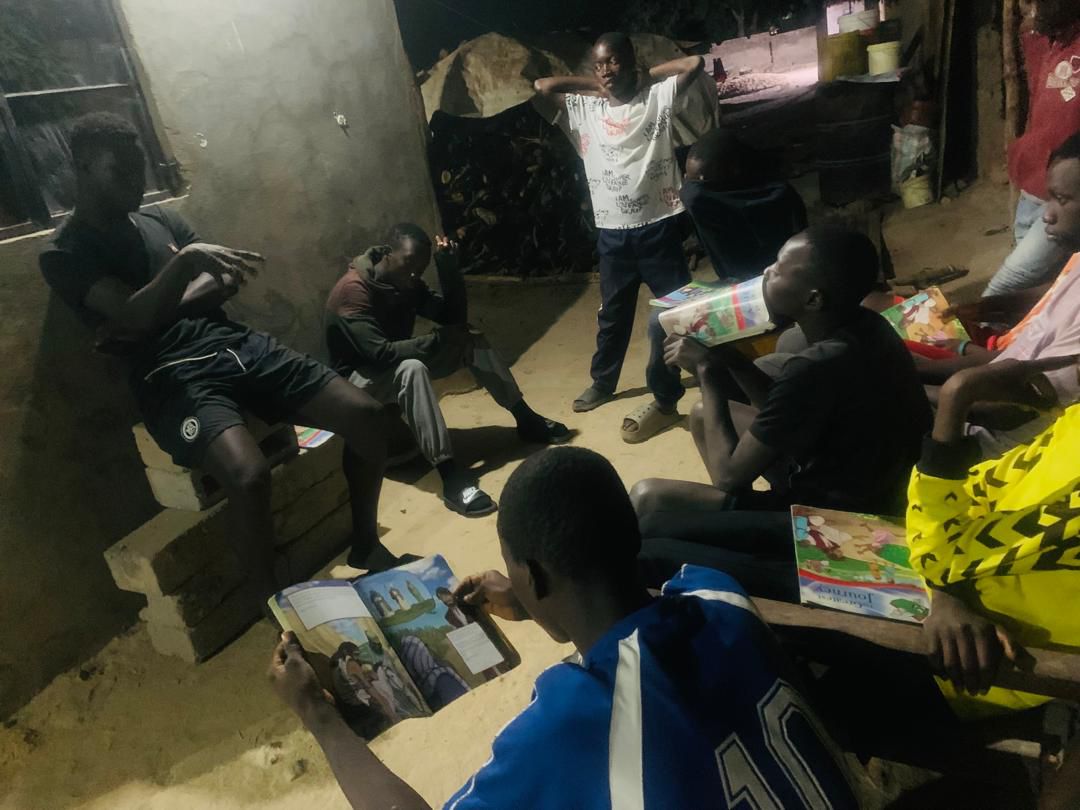 Youth DBS group gathering at night in The Gambia